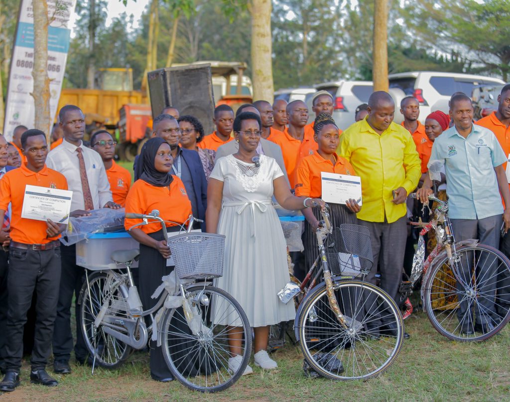 The Permanent Secretary Ministry of Health Dr. Diana Atwiine handing over bicycles and certificates to Community Health Workers during at Lwengo district headquarters in western Uganda.