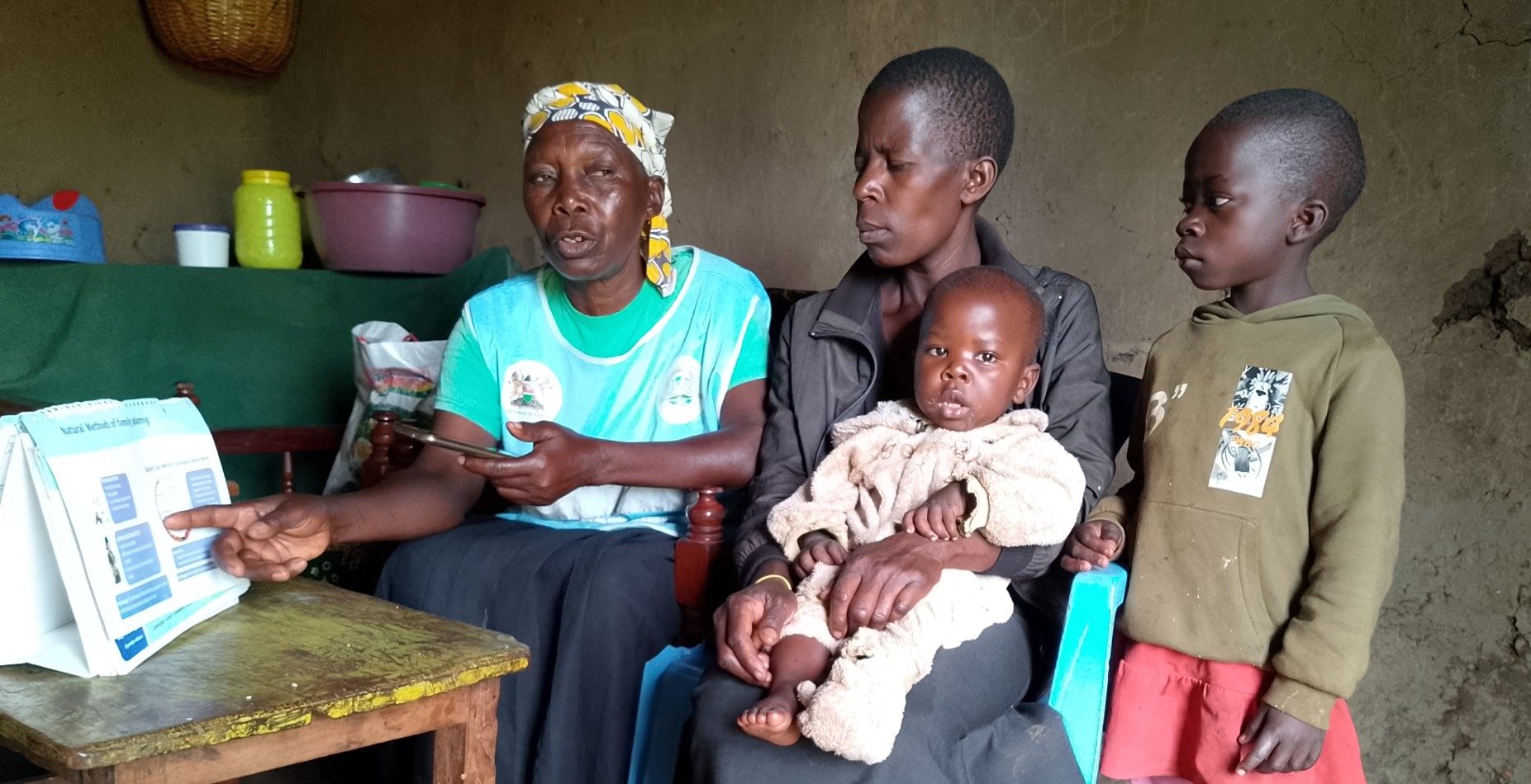 Roselyne Owuor from Kisumu, Kenya with her family and Wilkista Juma Owinyo, a Community Health Promoter 2