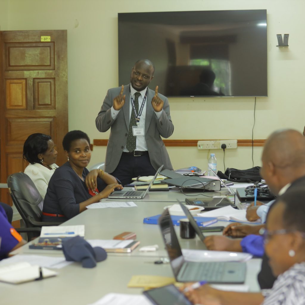 Dr. Bagala John Paul, Ag. Assistant Commissioner for Reproductive and Infant Health at MoH addresses partners and district officials on strengthening maternal and child health systems through collaboration and evidence-based strategies.
