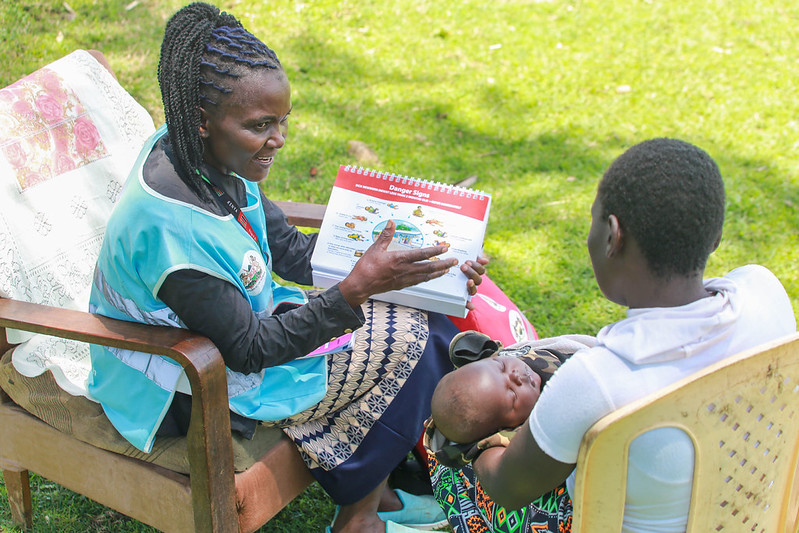 CHW Carolyne Nanjala attends to a client, Jescah and her two-months-old baby in Muteremko 'A' Village, Bungoma County.